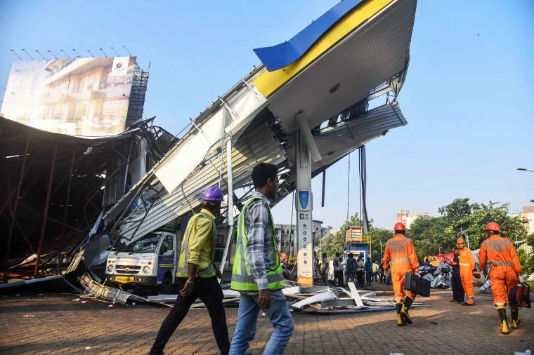 Rescue operations during the Mumbai storm news 2024, with emergency crews at the Ghatkopar site where a billboard collapsed, highlighting the severity of the storm's impact.
