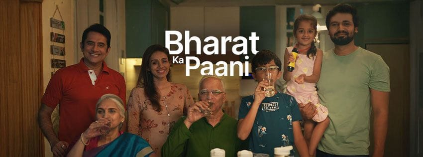 A symbolic image from ZeroB’s ‘Bharat Ka Paani’ campaign showing a diverse group of people—urban workers, rural families, children, and elders—gathered around a clean water source with the Indian map in the background, representing ZeroB’s mission to deliver safe drinking water across the nation.