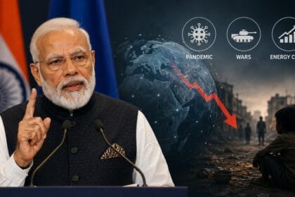 PM Modi Warns World Could Be Pushed Back Into Poverty during a speech in The Hague, with visuals showing global economic decline, wars, pandemic icons, energy crisis symbols, and poverty-stricken surroundings.